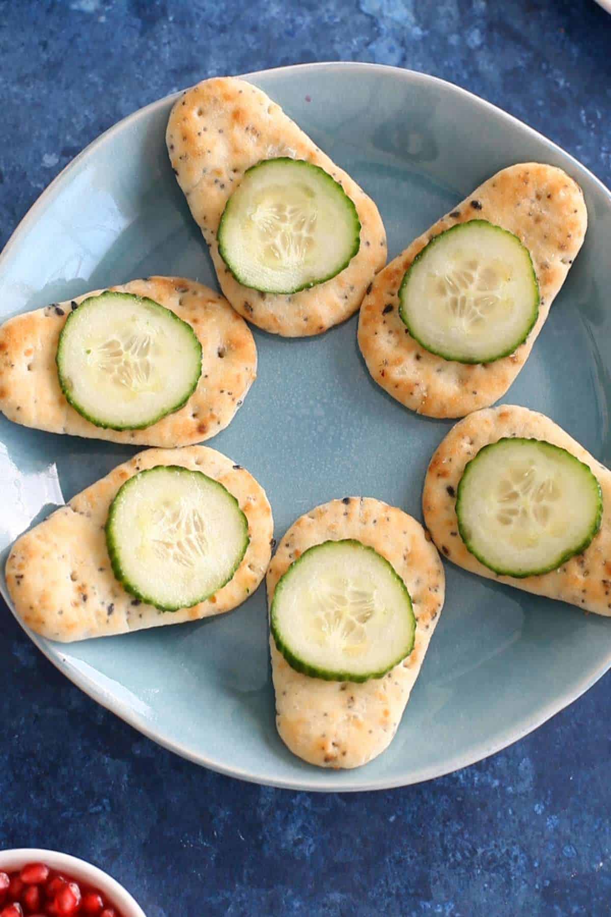 Mini naan with cucumber slices.