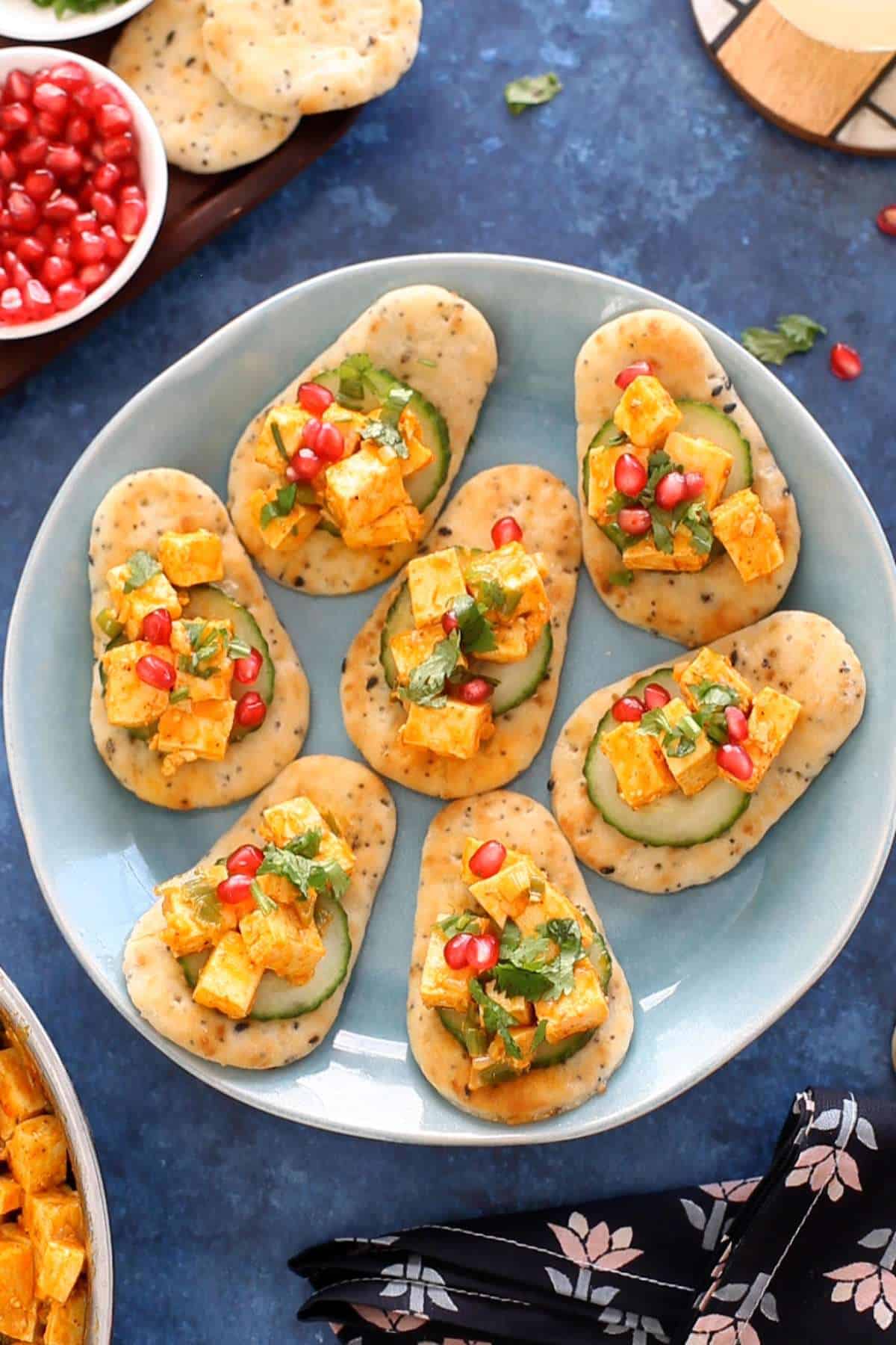 Assembled peri peri paneer bites on a blue plate.