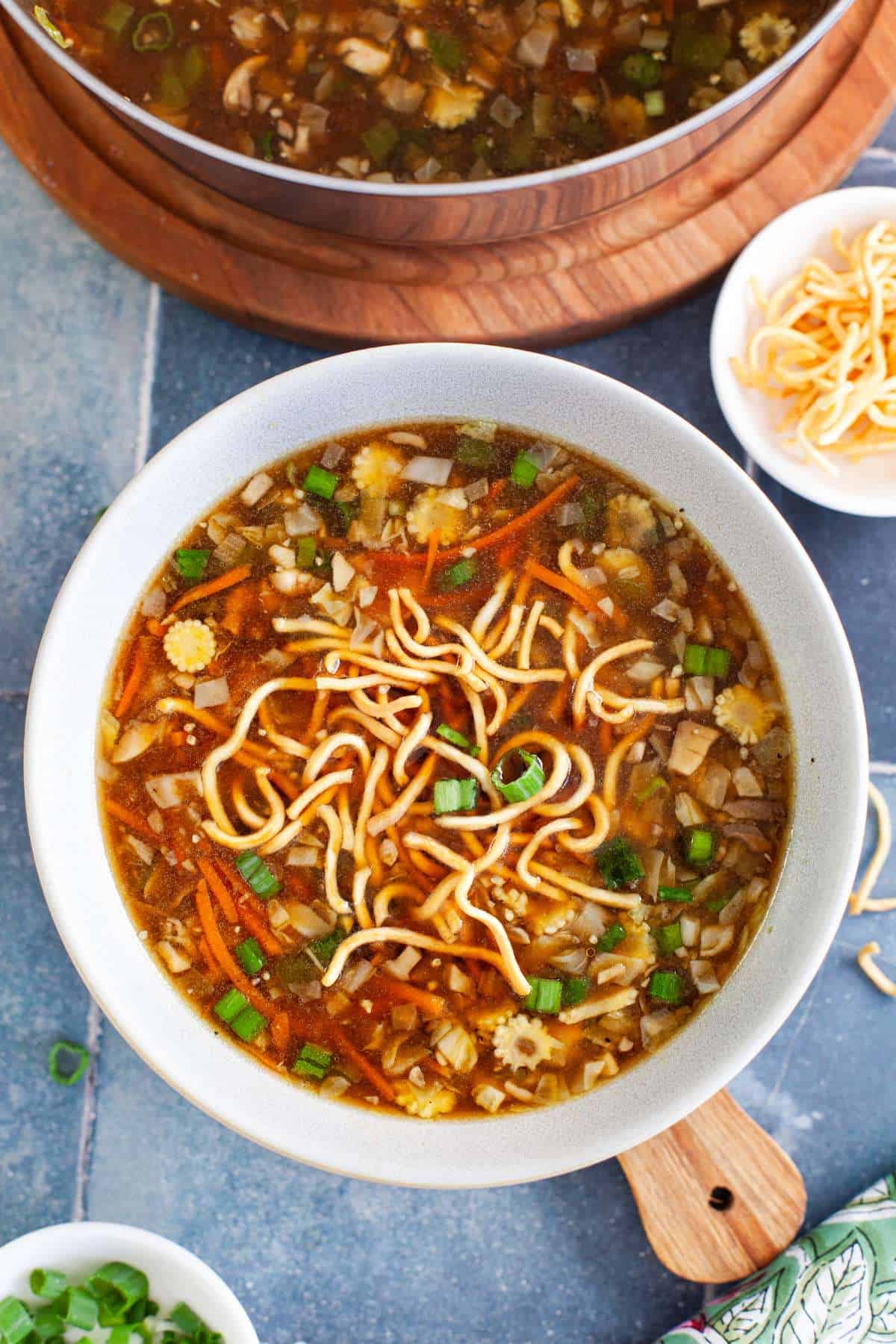 Indo Chinese hot chicken soup served in a grey bowl.