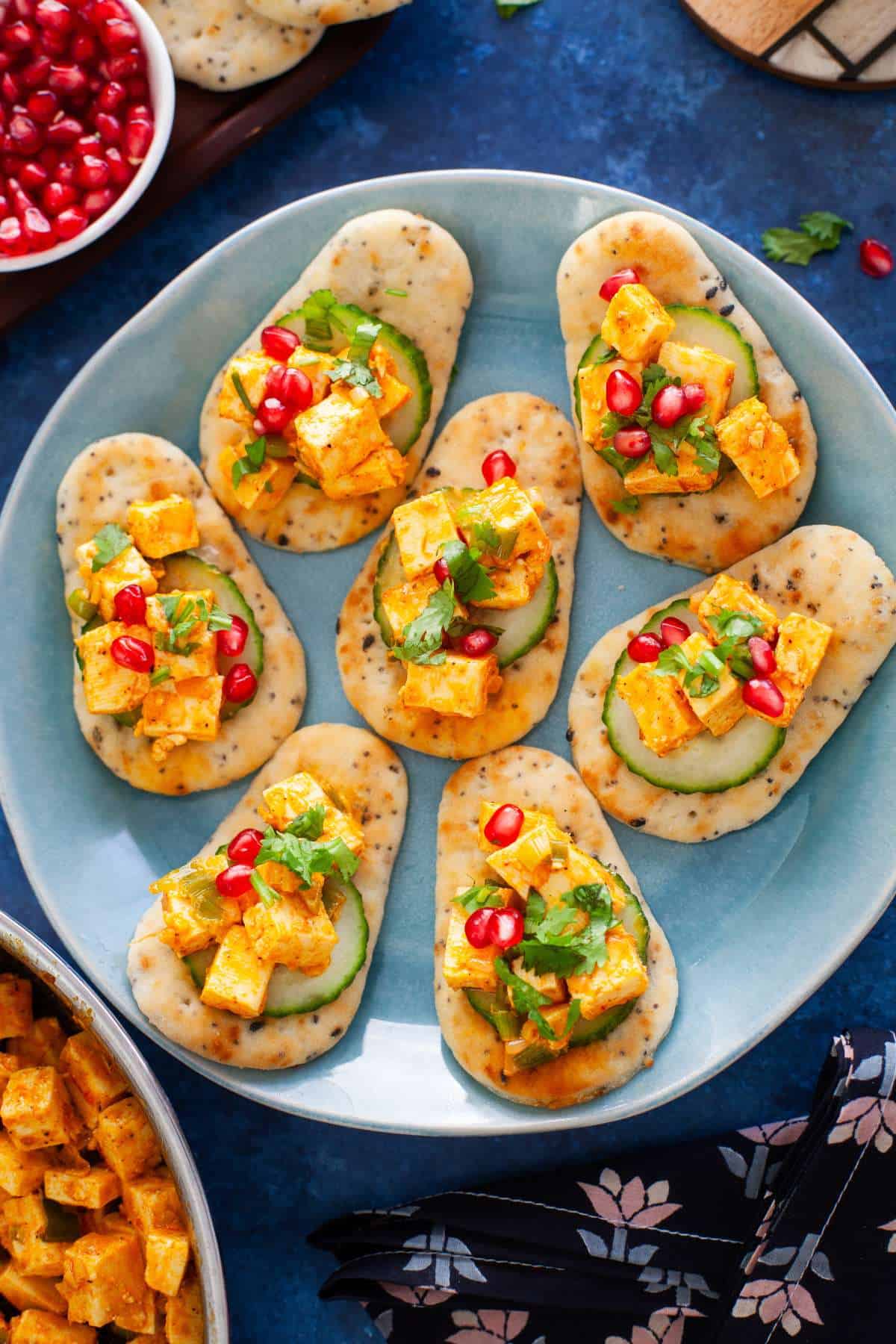 Peri peri paneer naan bites appetizer on a blue plate.