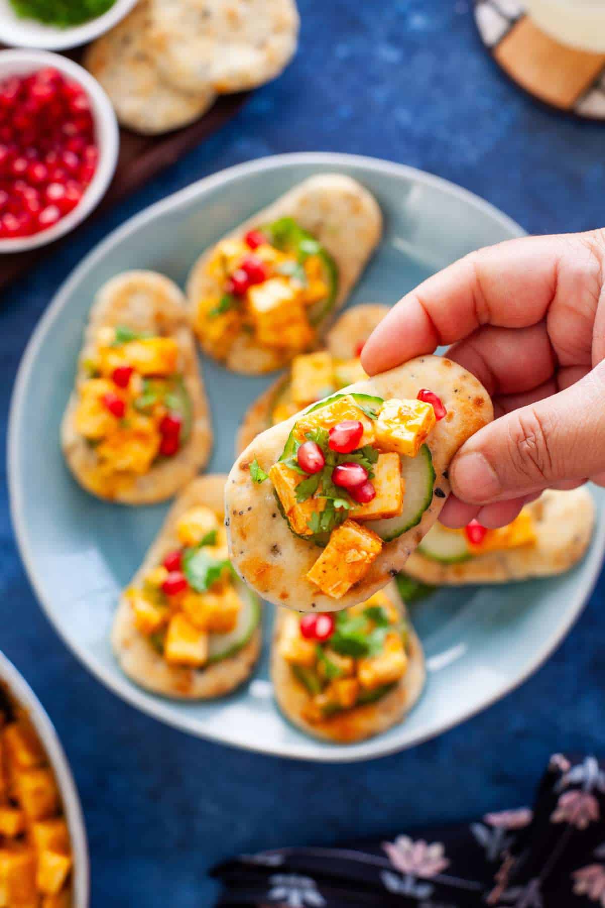 Holding a mini naan with peri peri paneer.