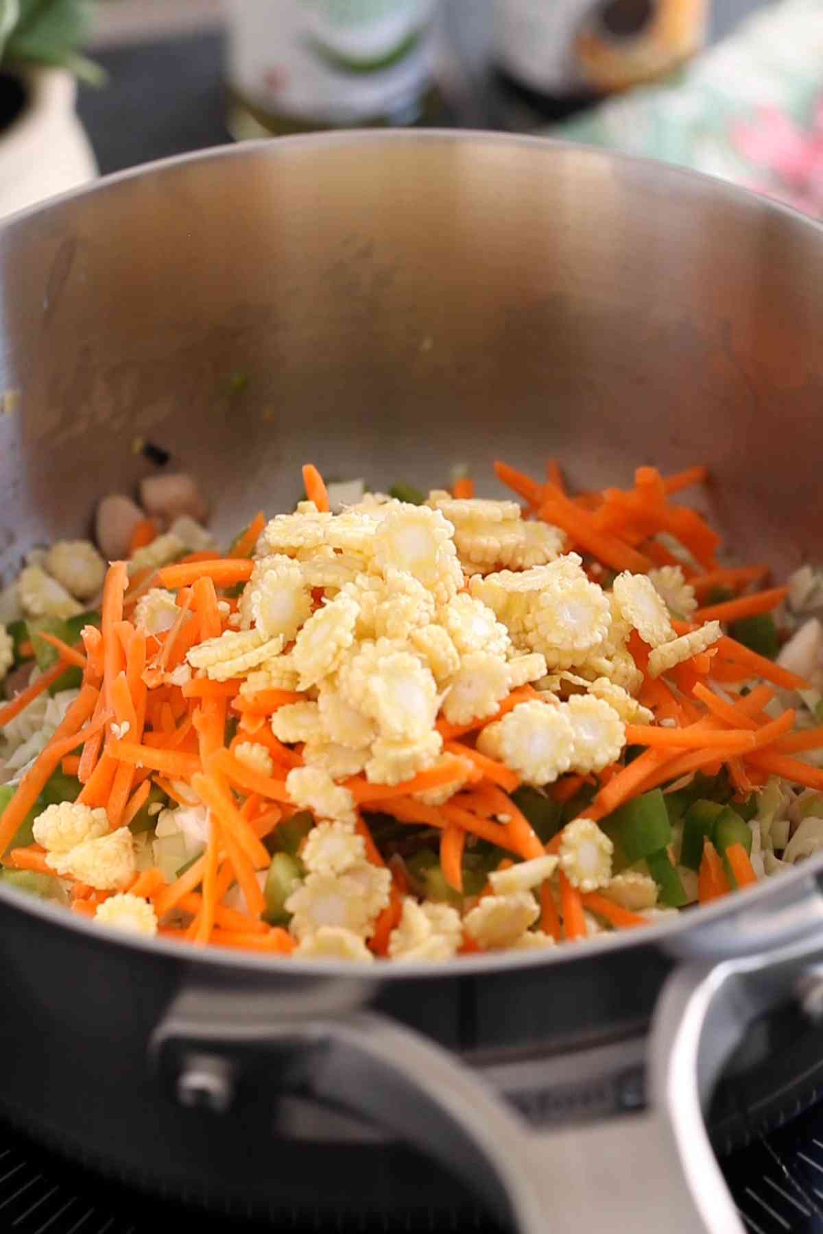 Add all the vegetables to the cooked chicken.