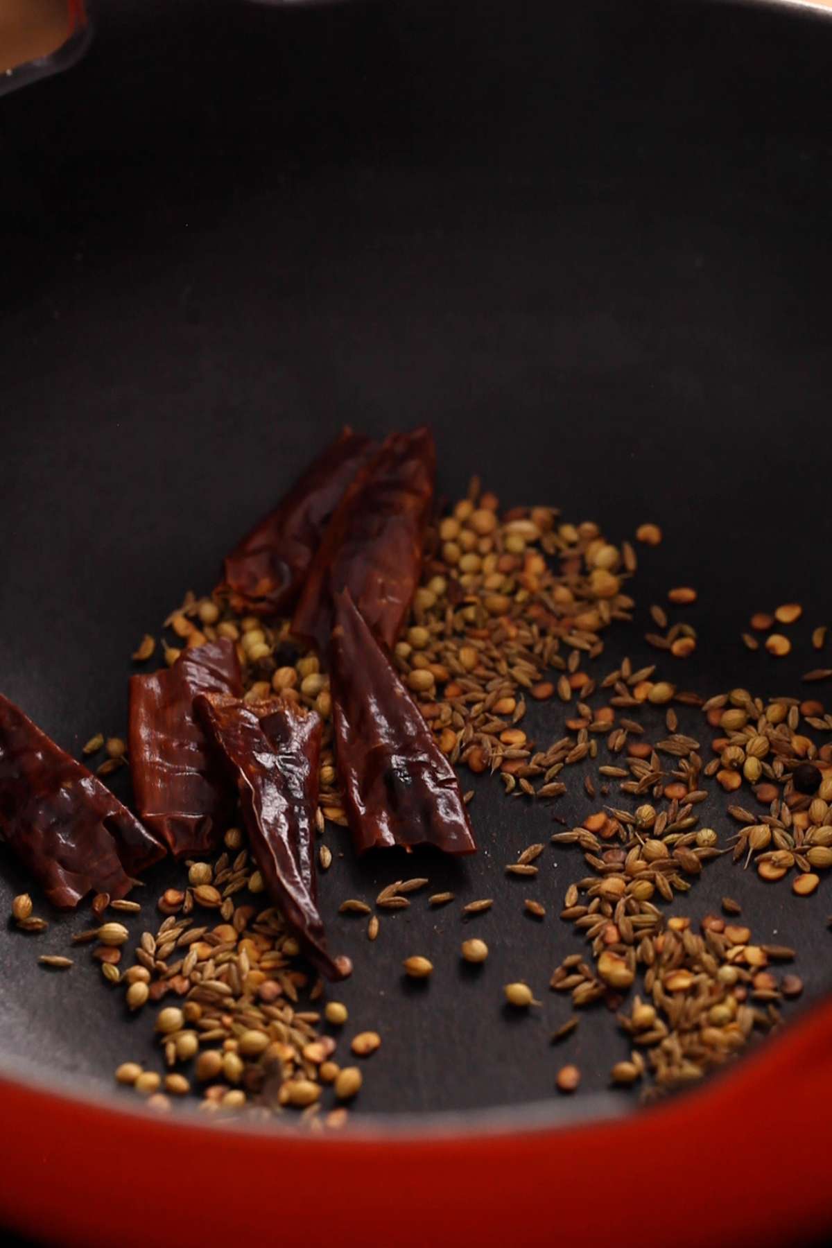Whole spices dry roasted in cooking pot.
