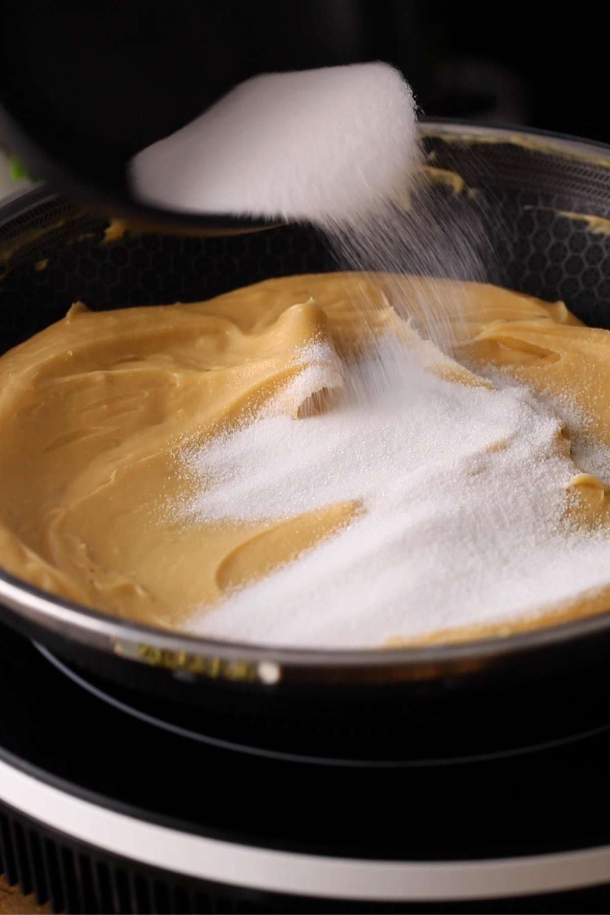 Add the sugar to the besan halwa.