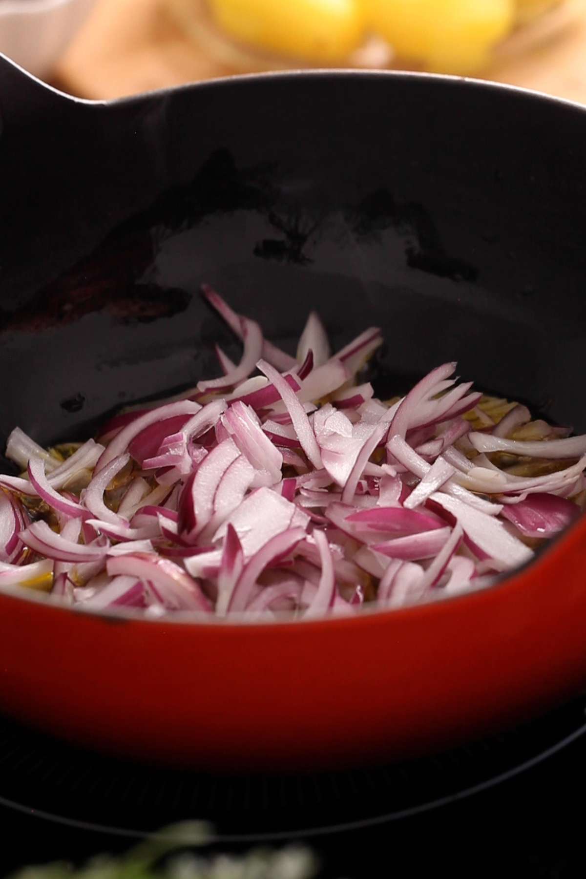 Sliced onion added to hot mustard oil.