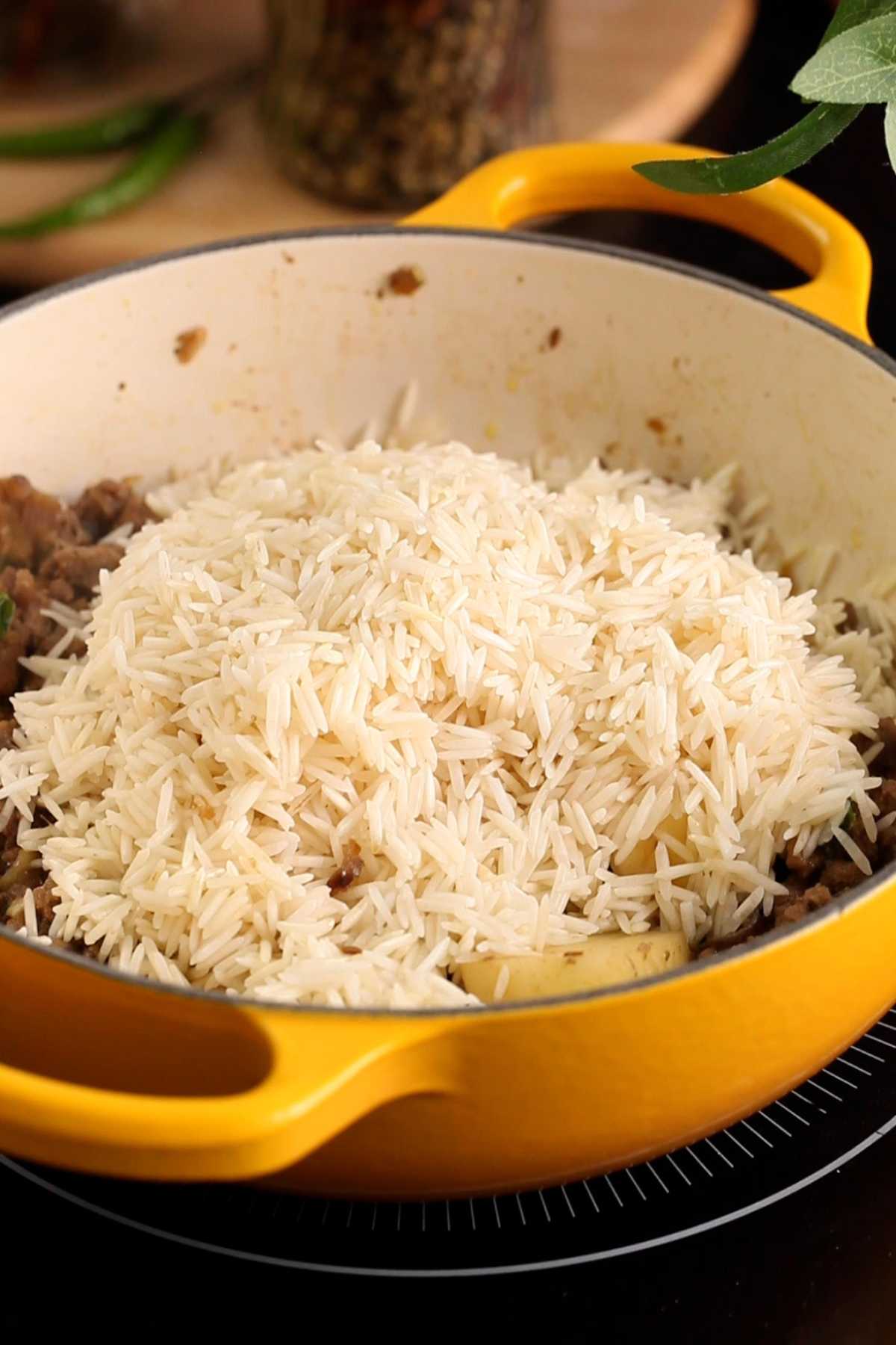Soaked rice is added to keema and potatoes. 