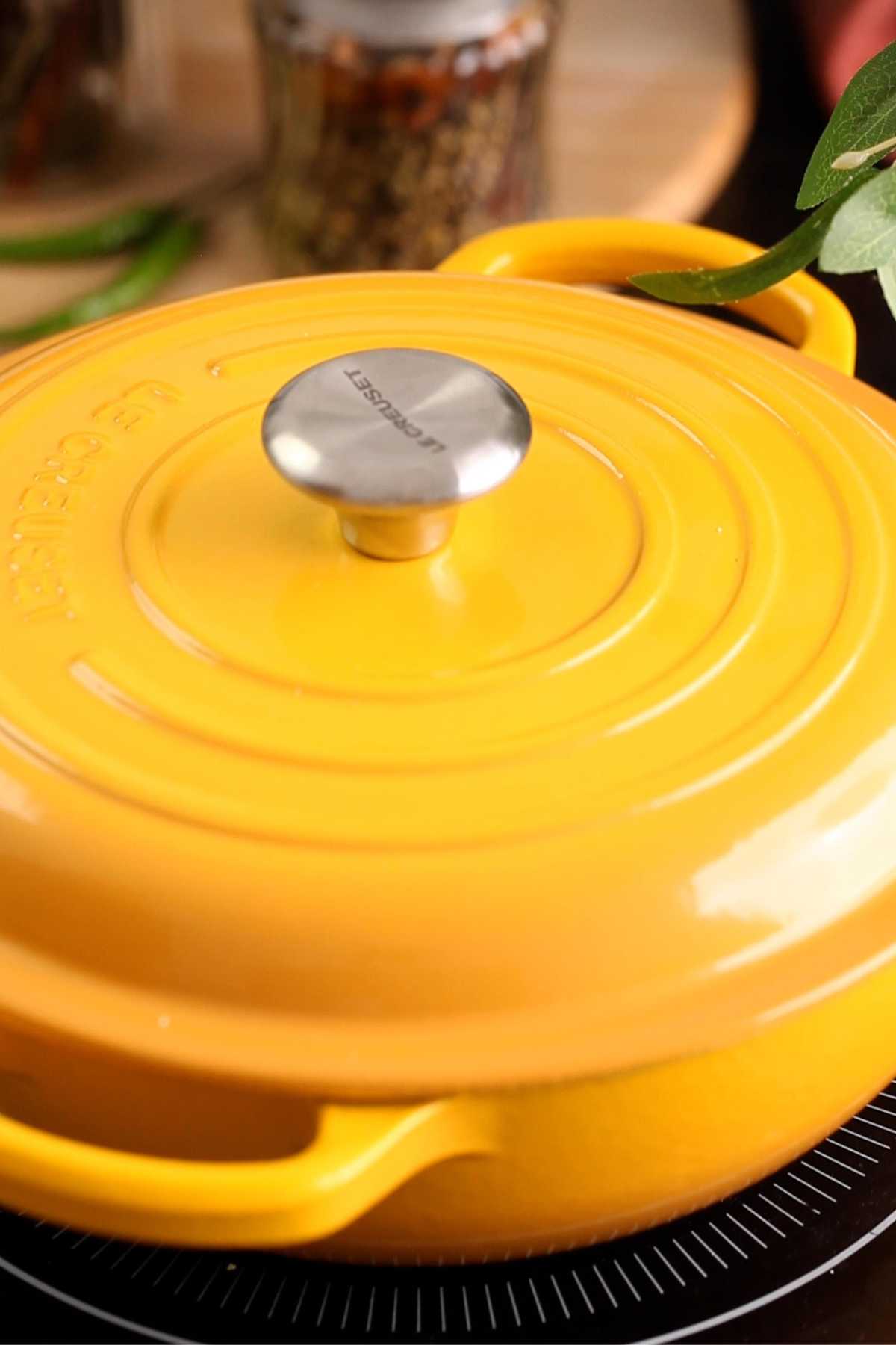 Keema pulao is cooking in a pot covered with lid.