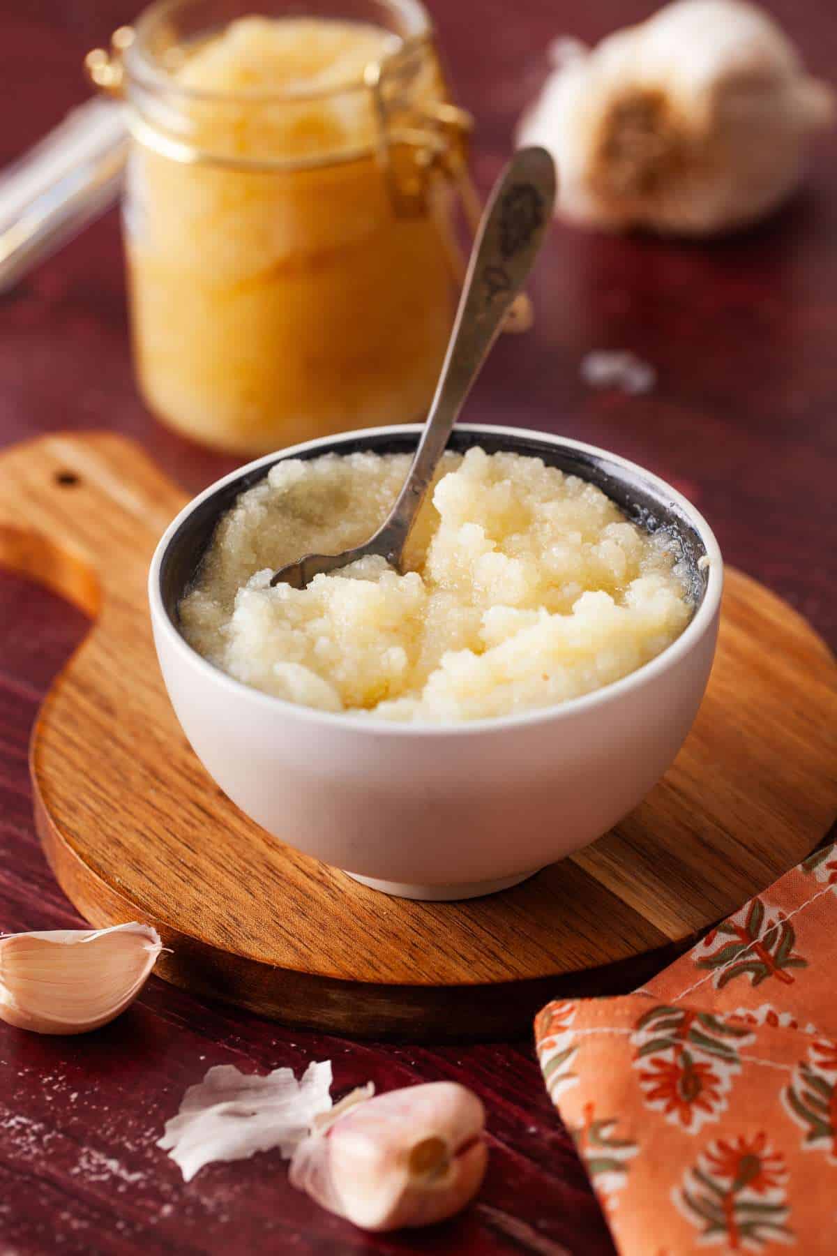 Garlic paste in a small bowl with spoon.