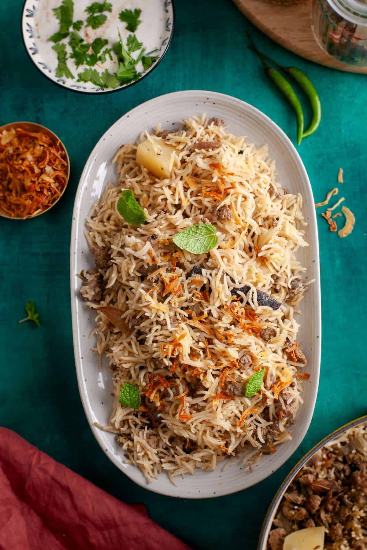 Keema Pulao served in a grey oval platter and garished with fresh mint leaves. 