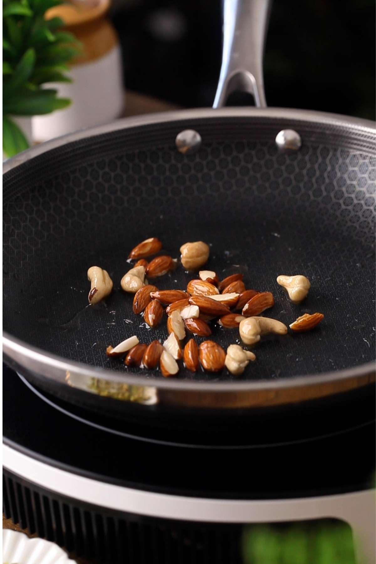 Roasting chopped nuts in ghee. 