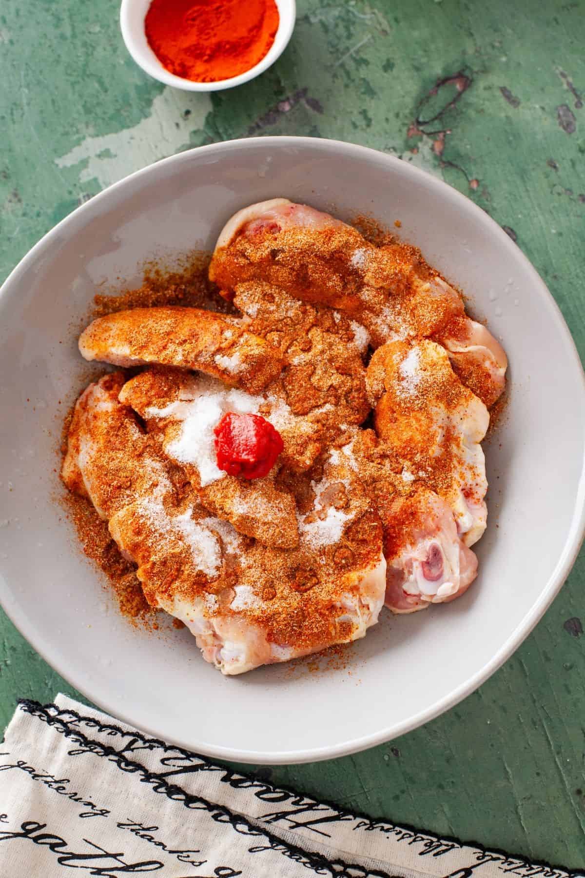 Chicken wings sprinkled with curry spices, tomato paste and salt.