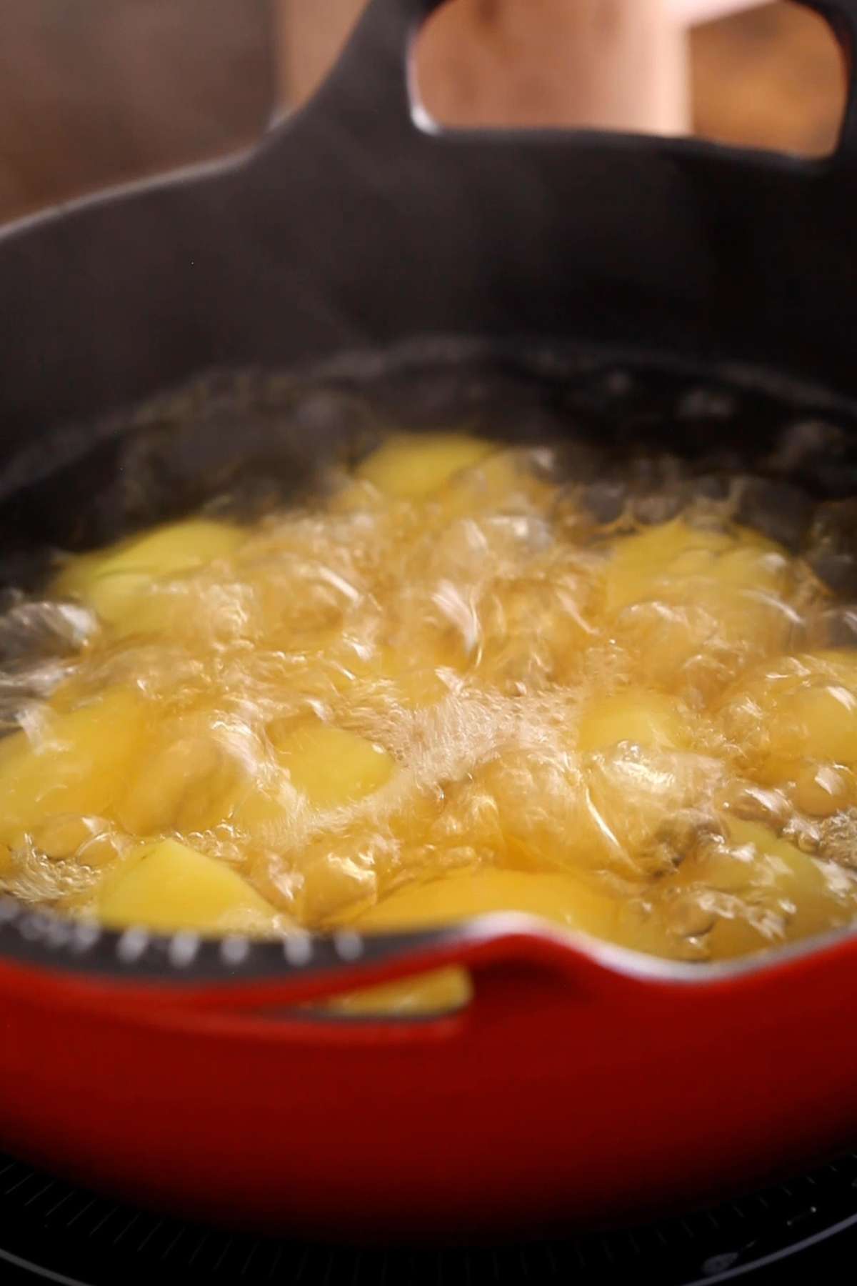 Par boiling baby poatoes in boiing water.