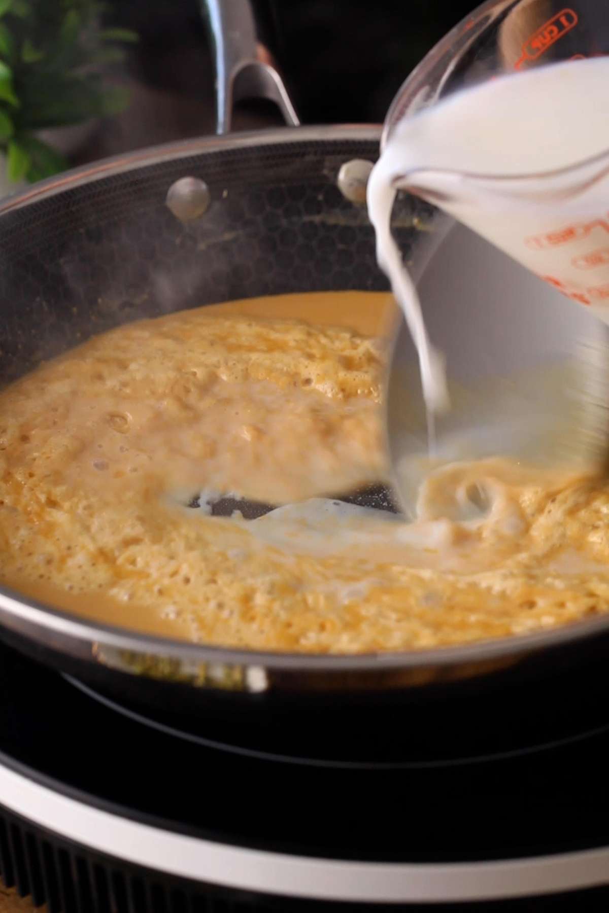 Adding milk and water to roasted besan.