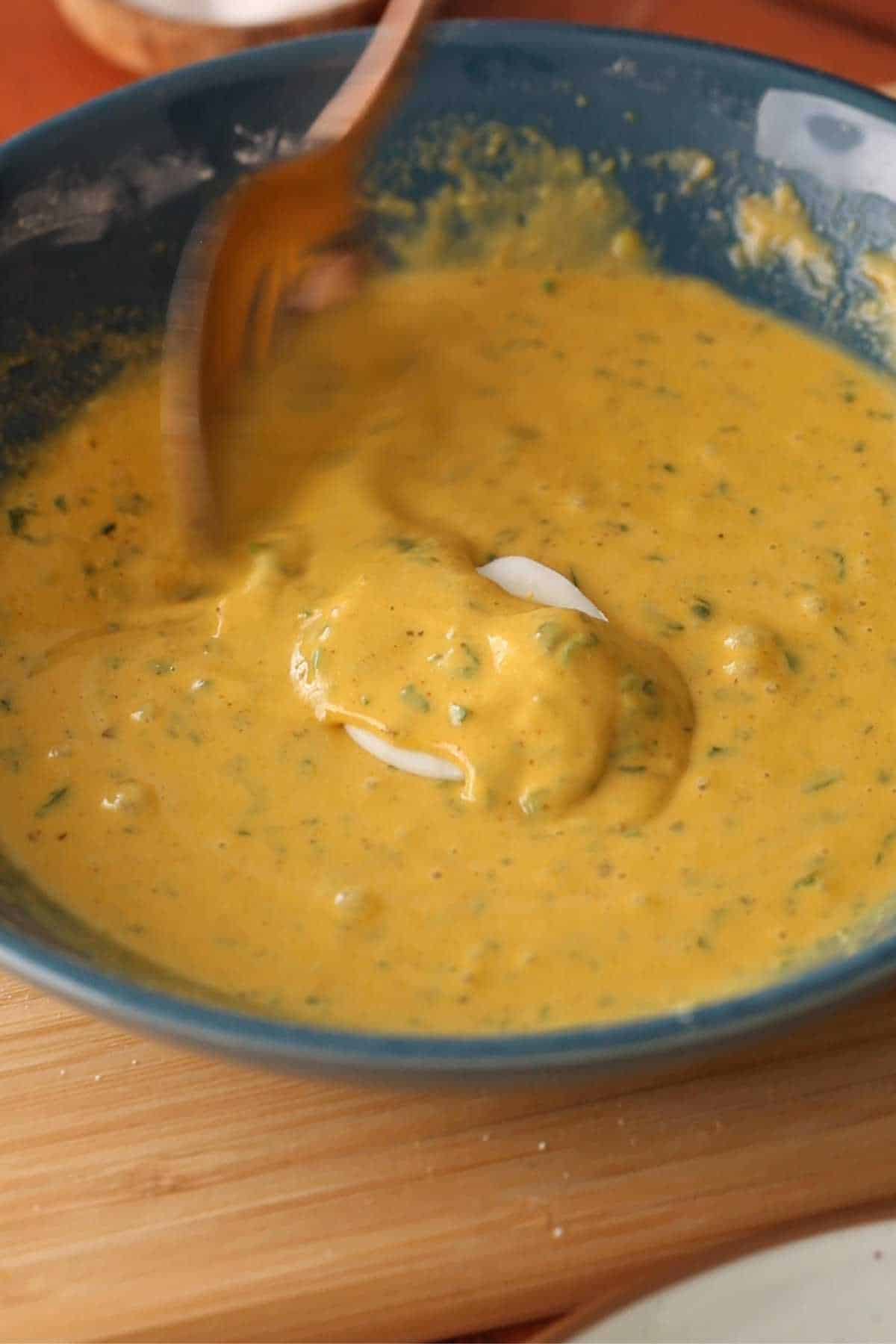 Coating the egg sliced with the batter.