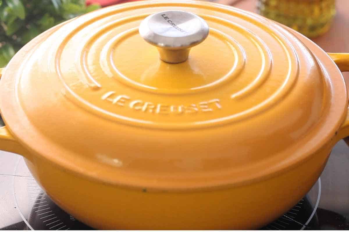 Cover the pot and slow cook lamb madras. 