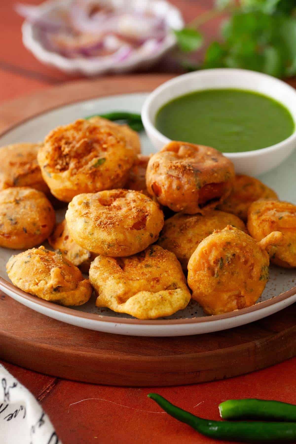 Side view of crispy egg fritters sprinkled with chaat masala.