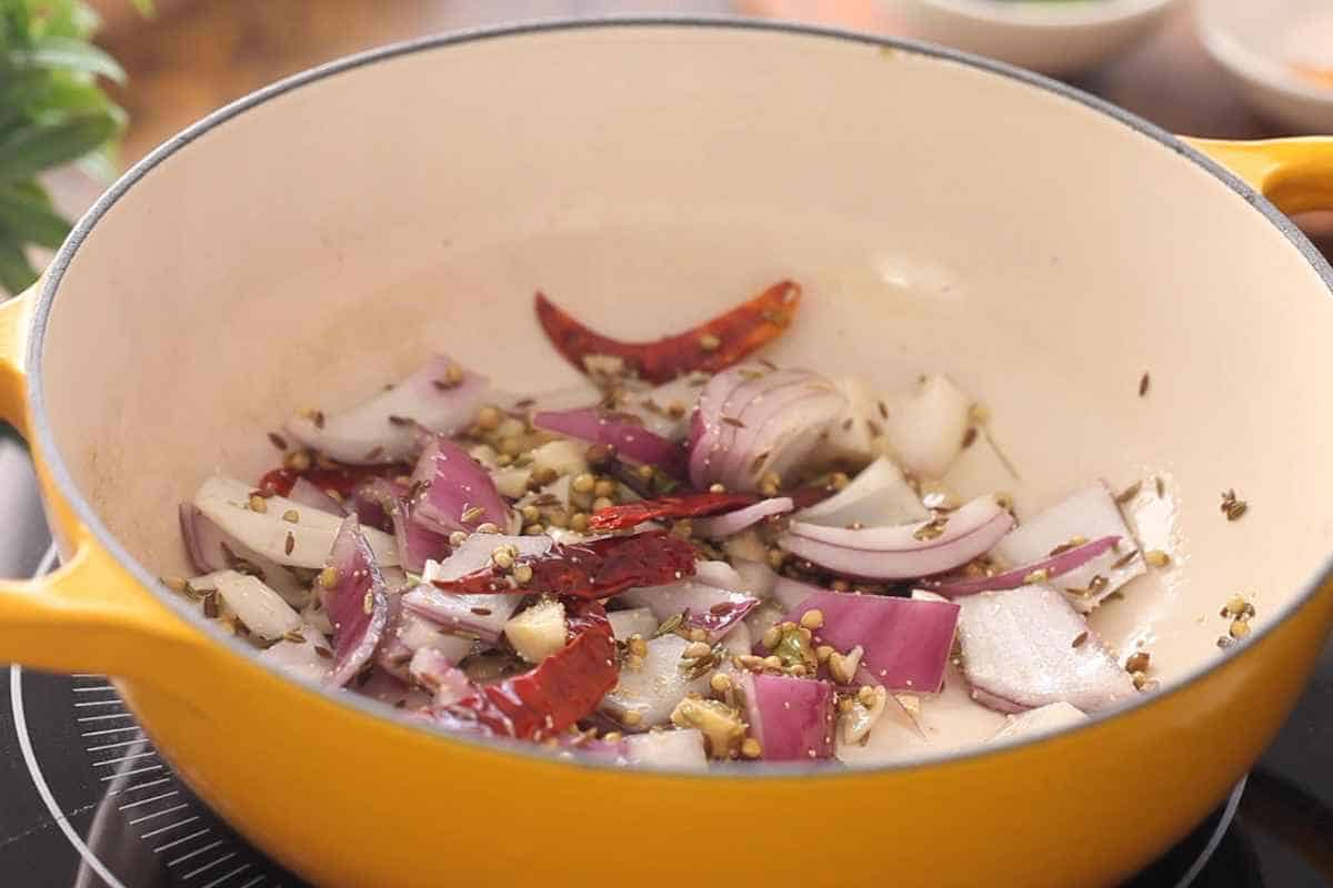 Frying onions with spices. 