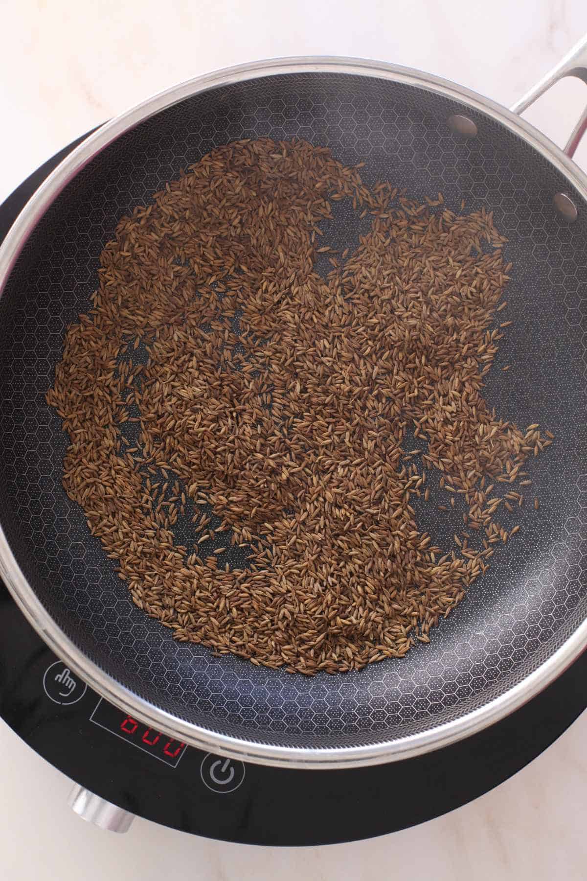 Roasted cumin seeds that are deep brpwn in color and smoky.