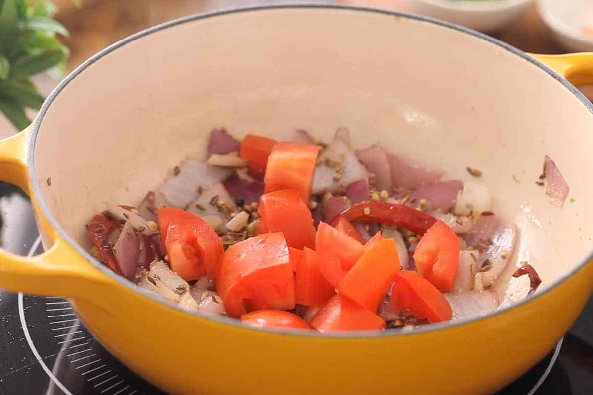 Next adding tomatoes to the onion & spices. 