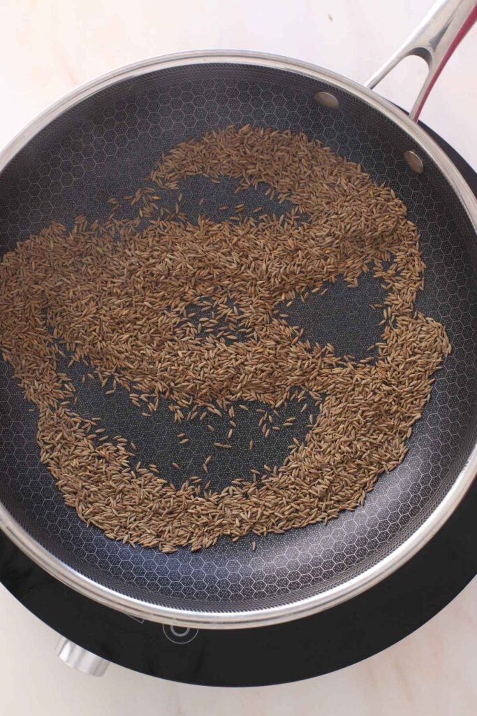 Cumin seeds getting slow roasted in hot pan.
