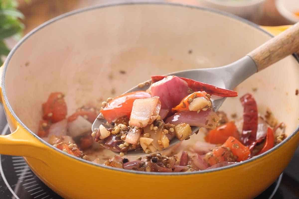 Tomatoes, onions and whole spcies are reading to grind. 