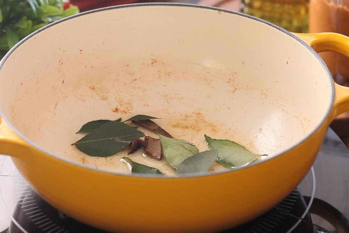 Curry leaves and spices crackling in hot oil.