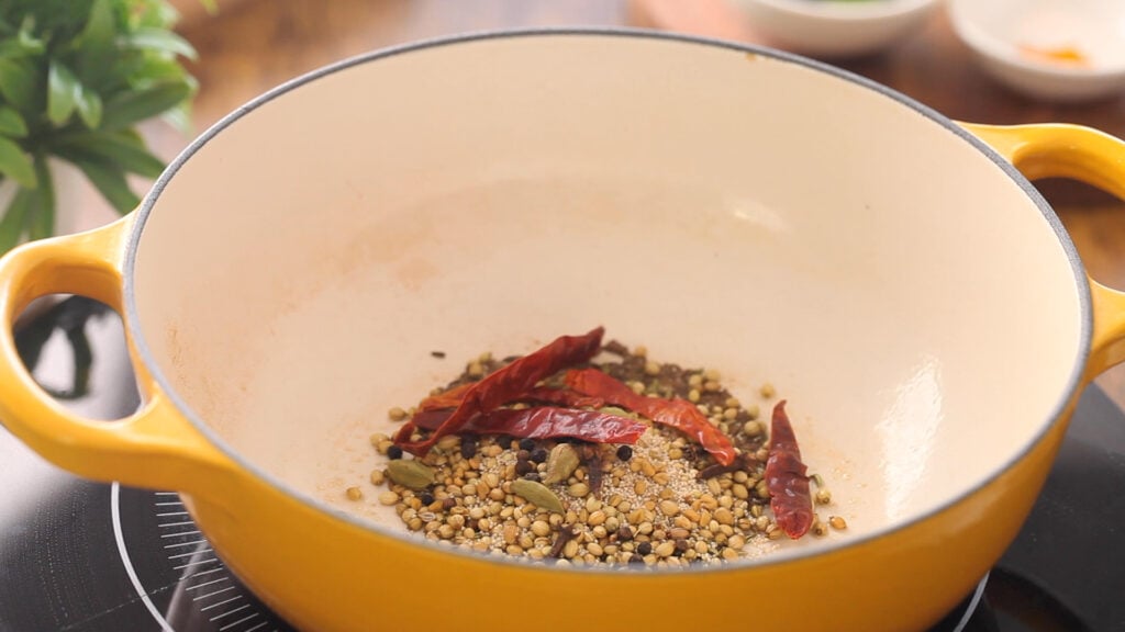 Whole Spices & dried red chilies frying in oil. 