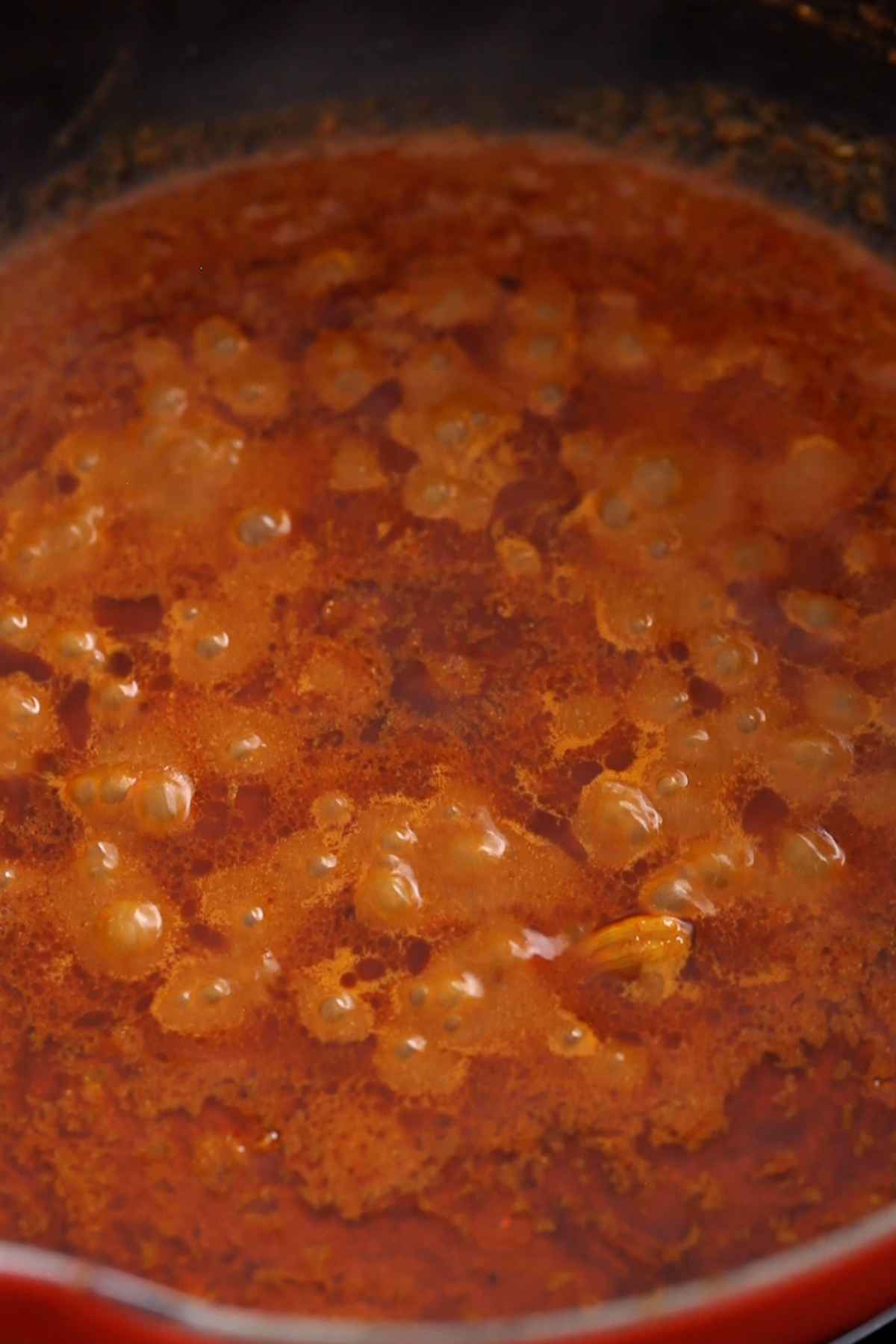 Kofta curry gravy simmering and oil is seperating.
