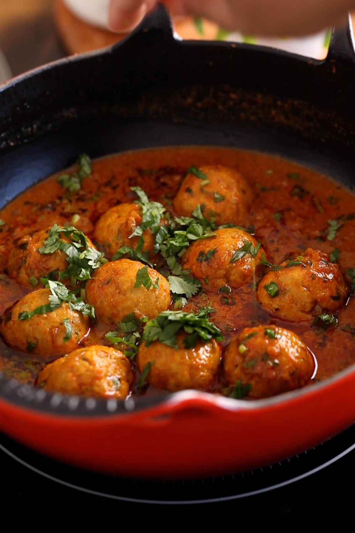 Chicken kofta maslaa is garnished with fresh chopped cilantro and ready to serve.