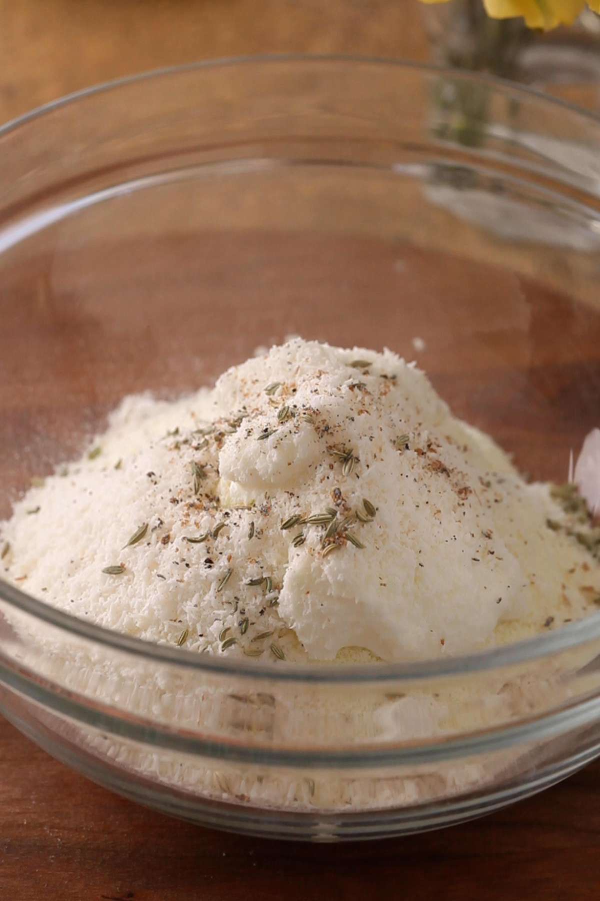 Malpua ingredients in a large glass bowl.