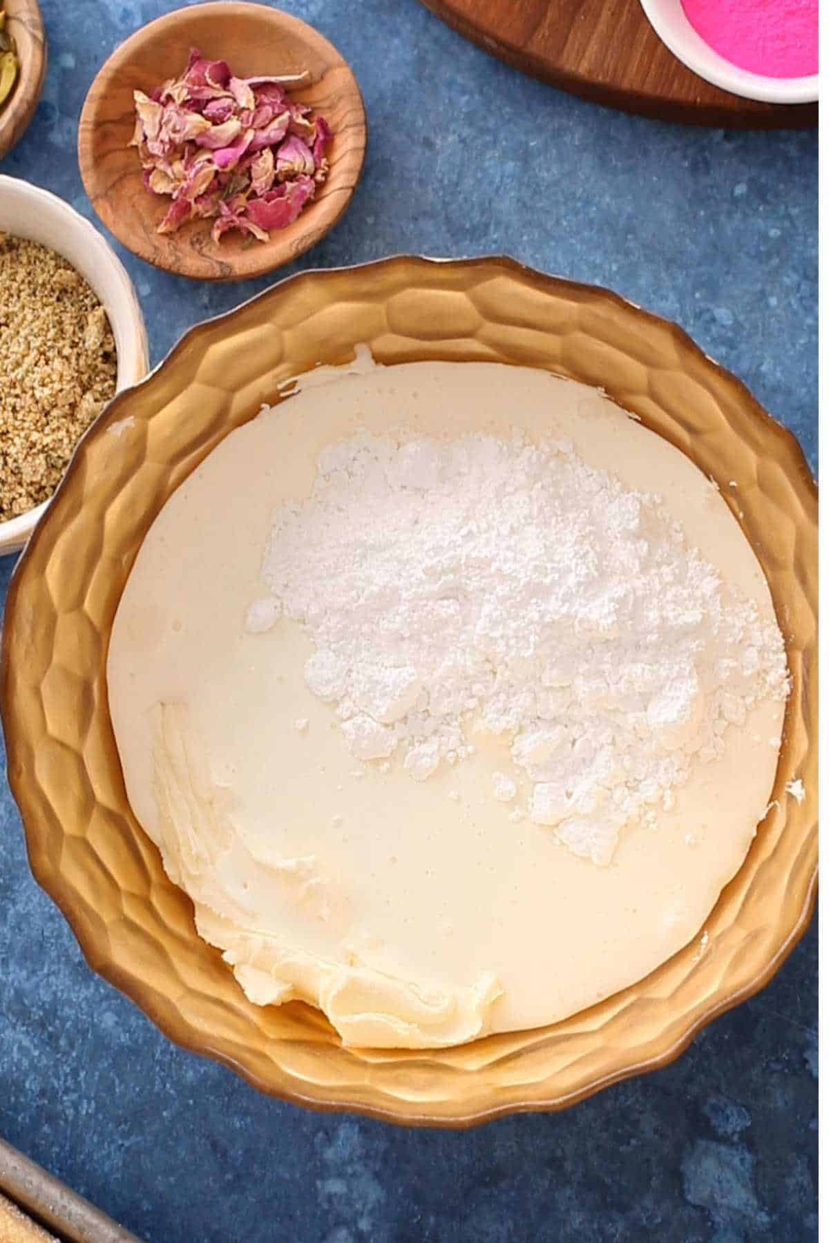 Masarpone cream ingredients place in a large gold bowl. 