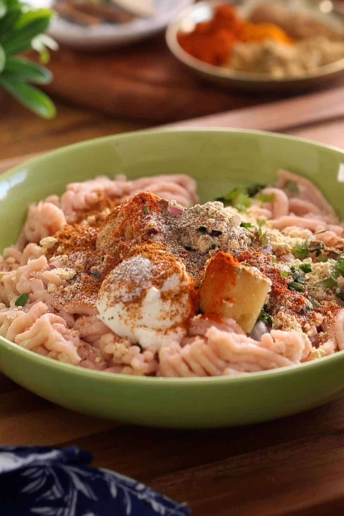 Ground Chicken with spices, herbs, yogurt and raw red onions.