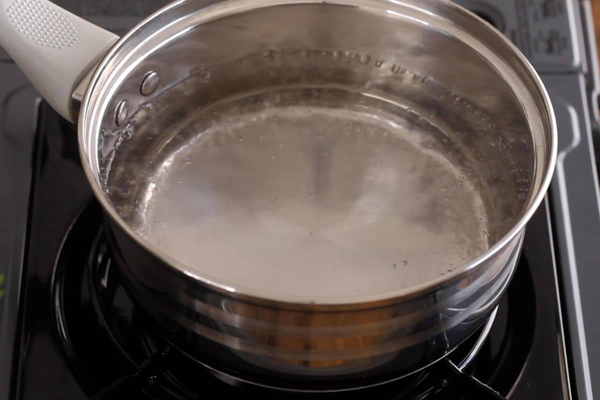 Boiling water in a stainless steel pot.