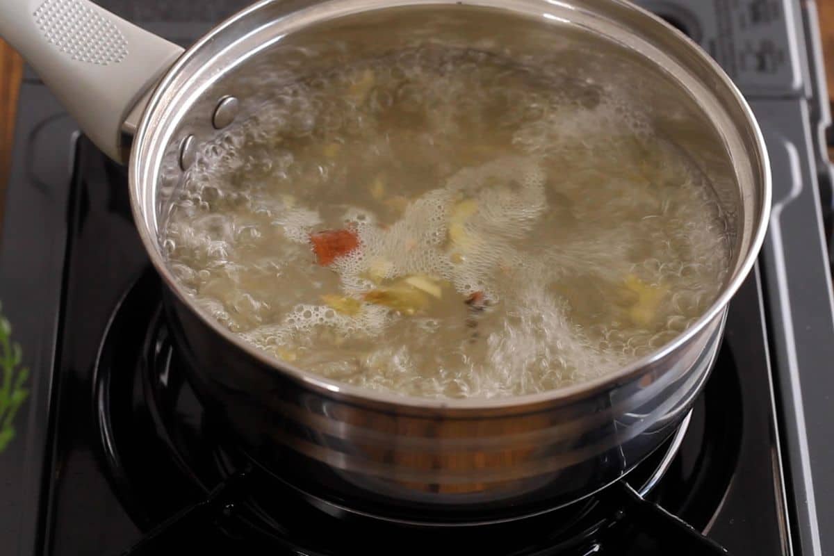 Infusing ginger and spices in the boiling water.