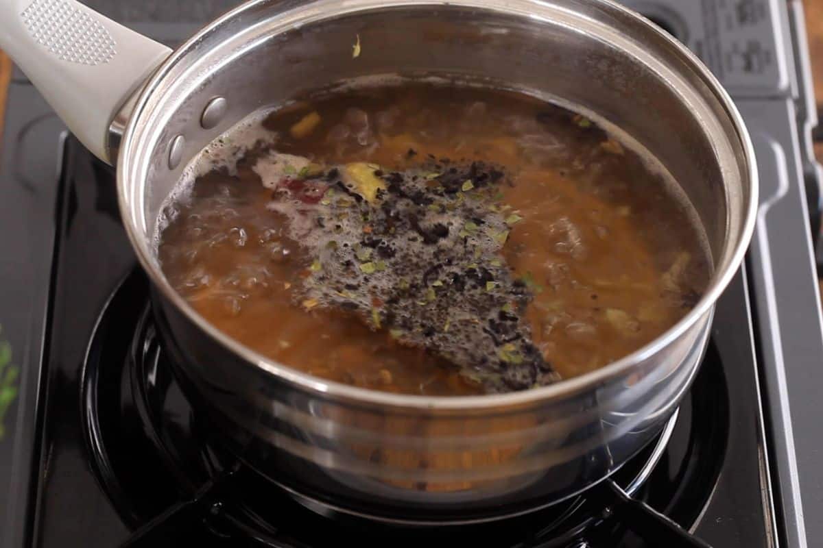 Black tea leaves added to boiling water. 