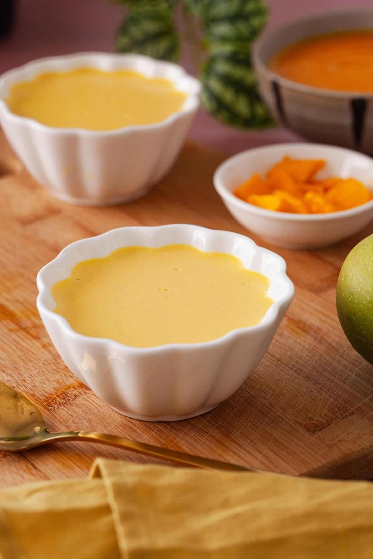 Panna cotta after it is set in white ramekins.