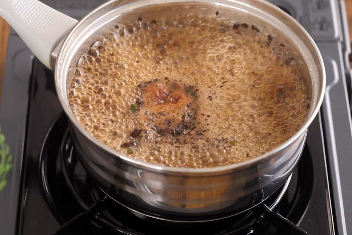 Black tea leaves blooming in boiling water.