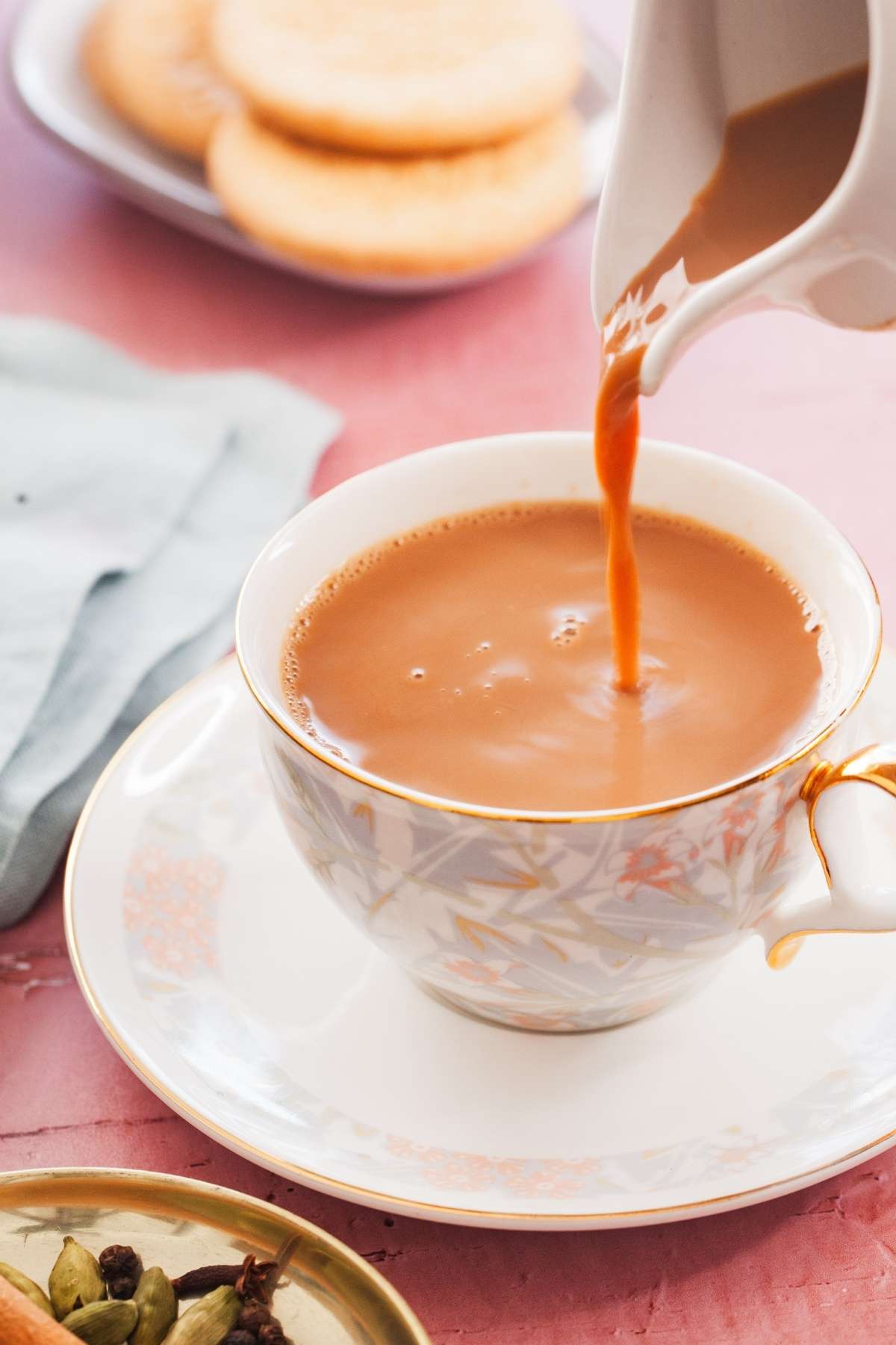 Action image of pouring chai in a tea cup. 
