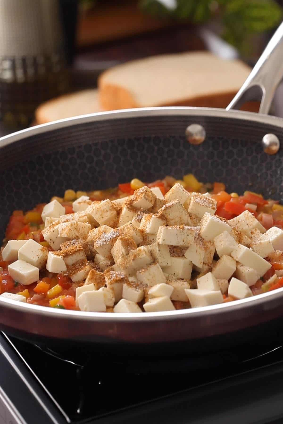 Adding spices to paneer.