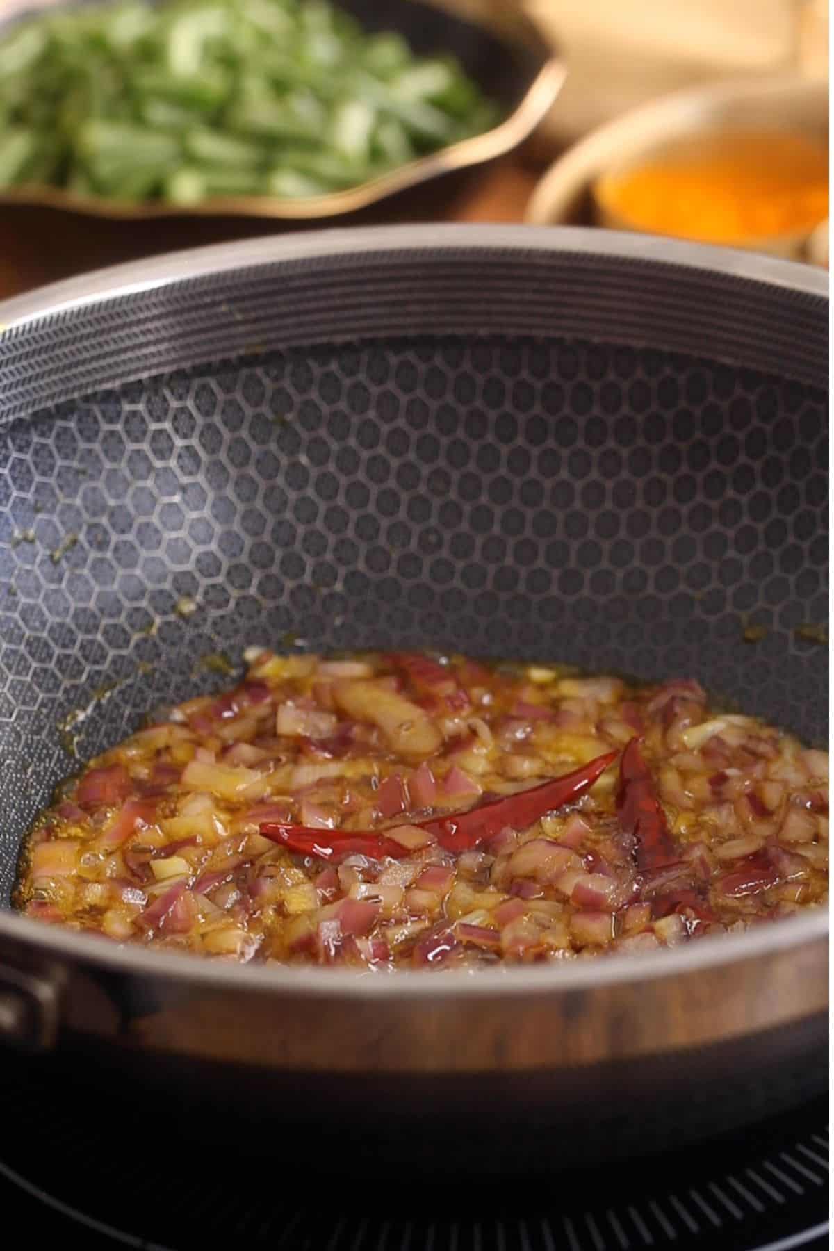 Browned onions in a black wok.