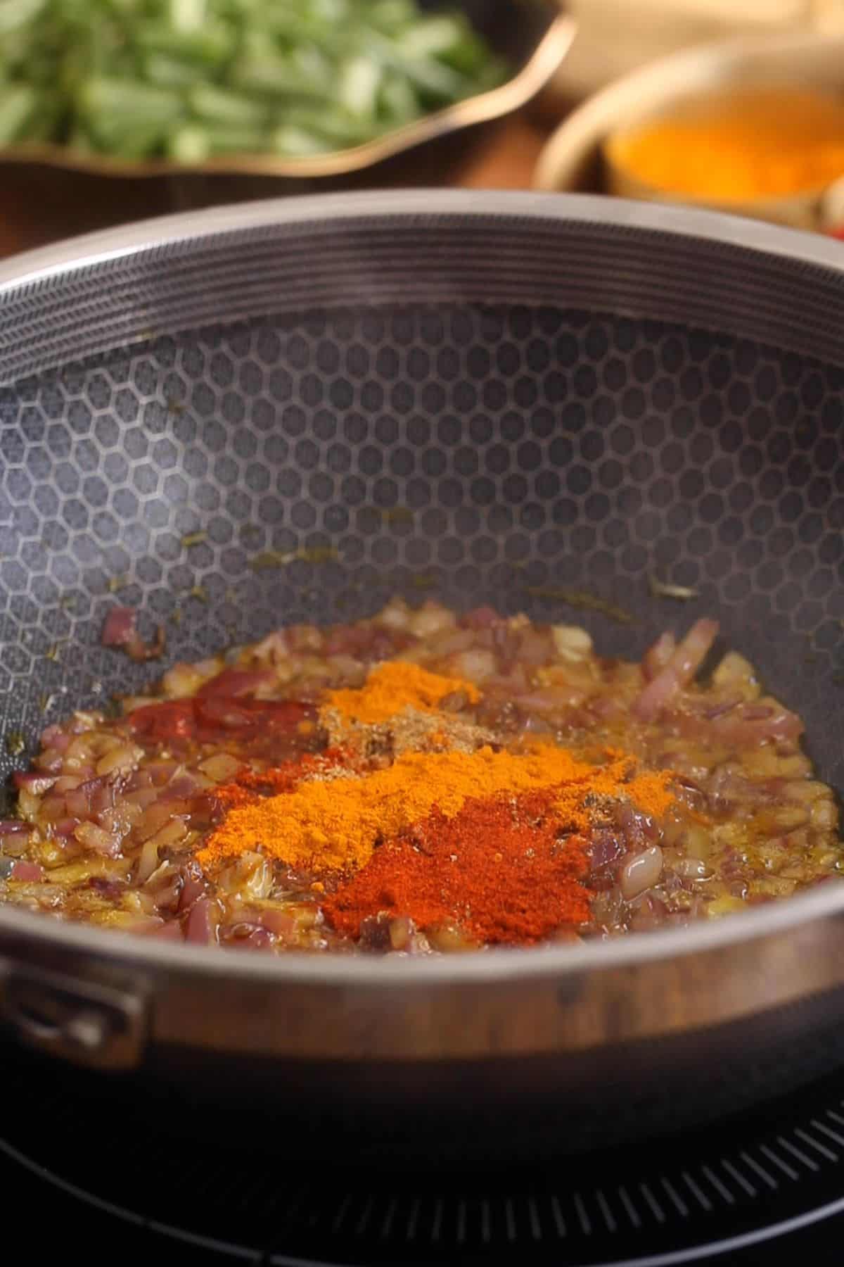 Spice powders added to browned onions.