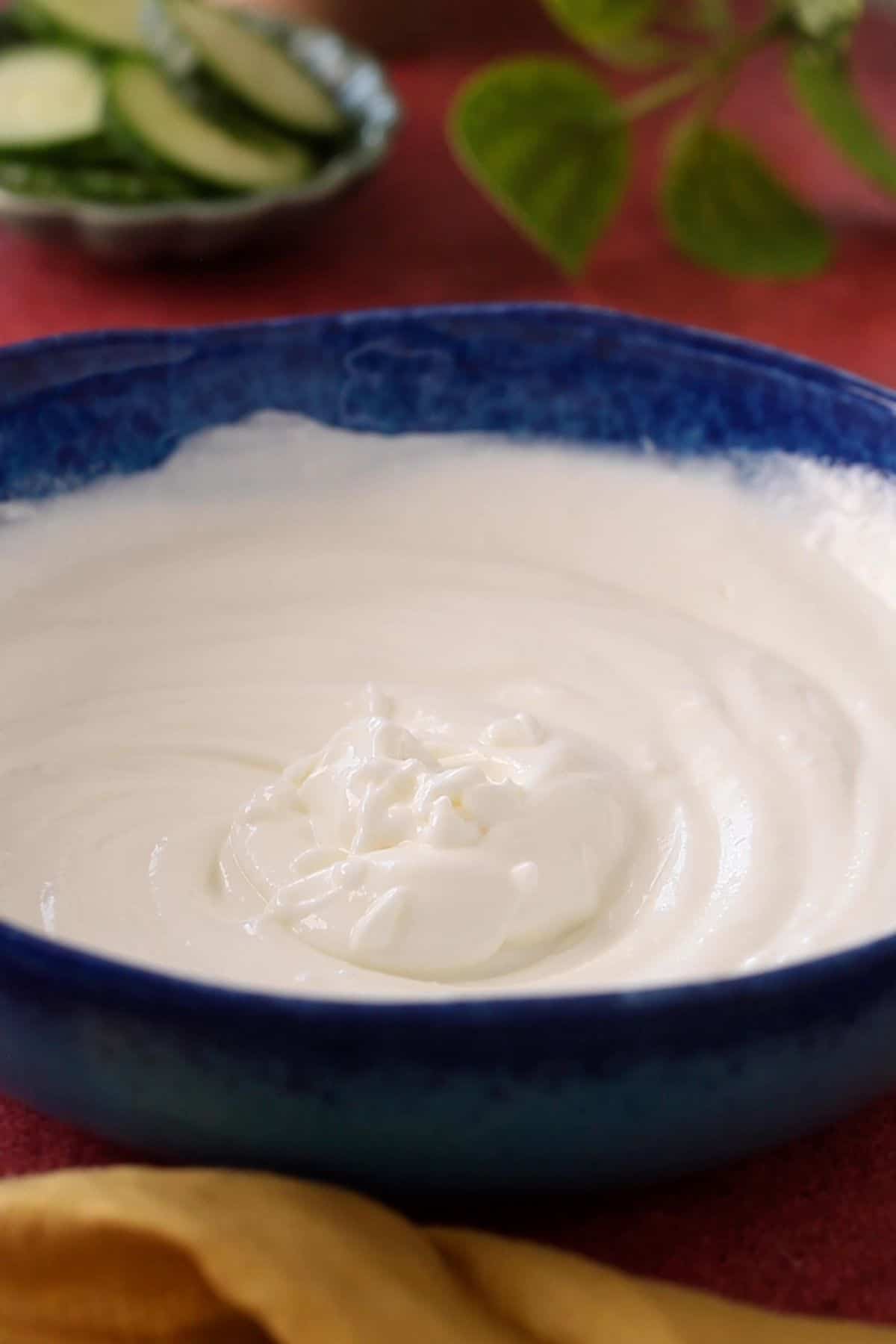 Plain Greek yogurt is whisked.