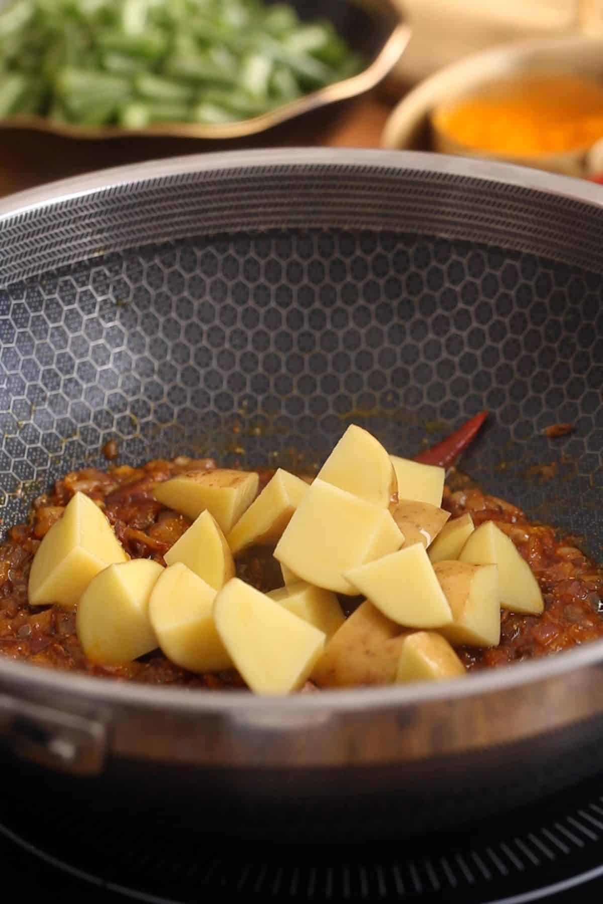 Potatoes cubes added to onion and spices.