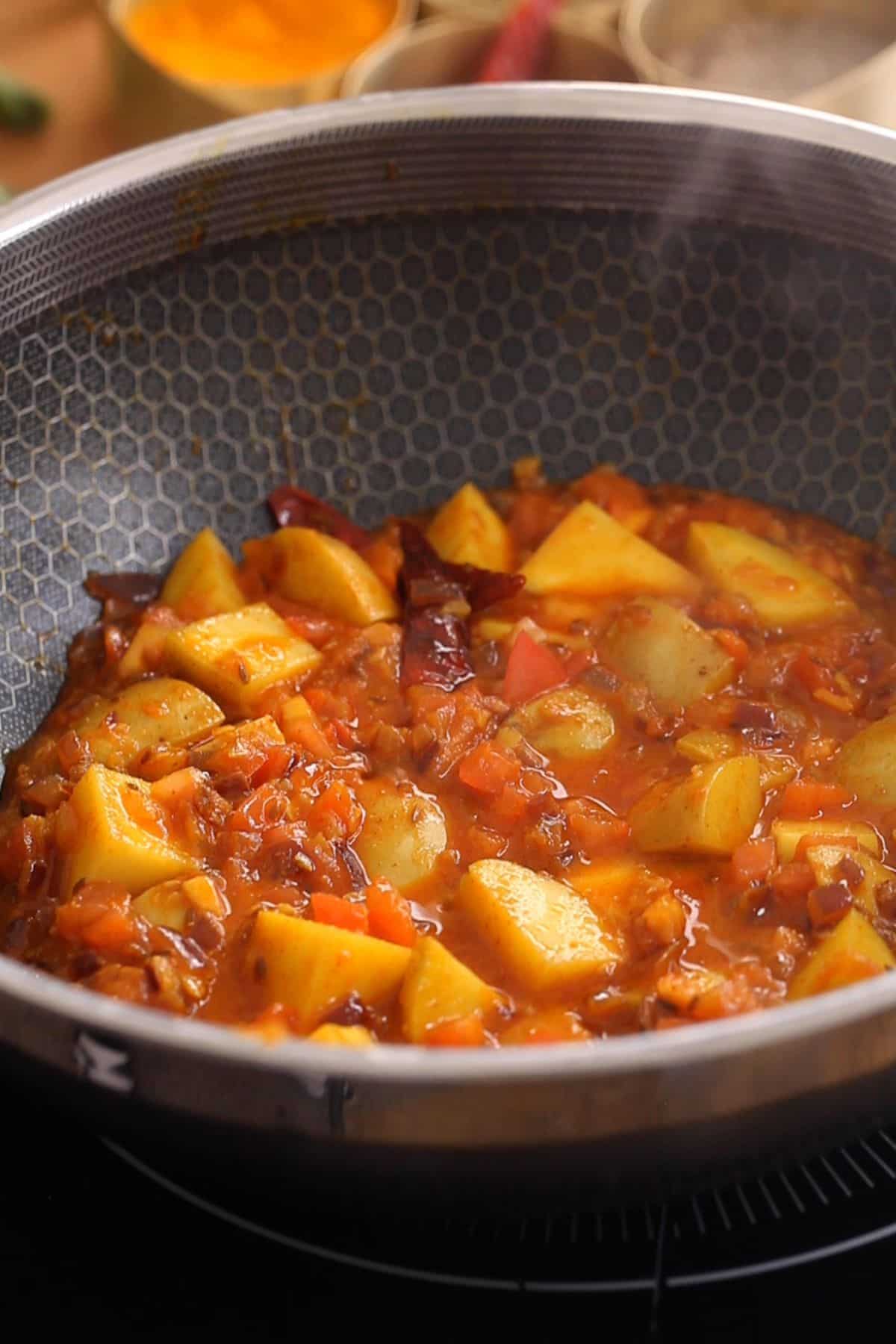 Partially cooked potatoes and masala.