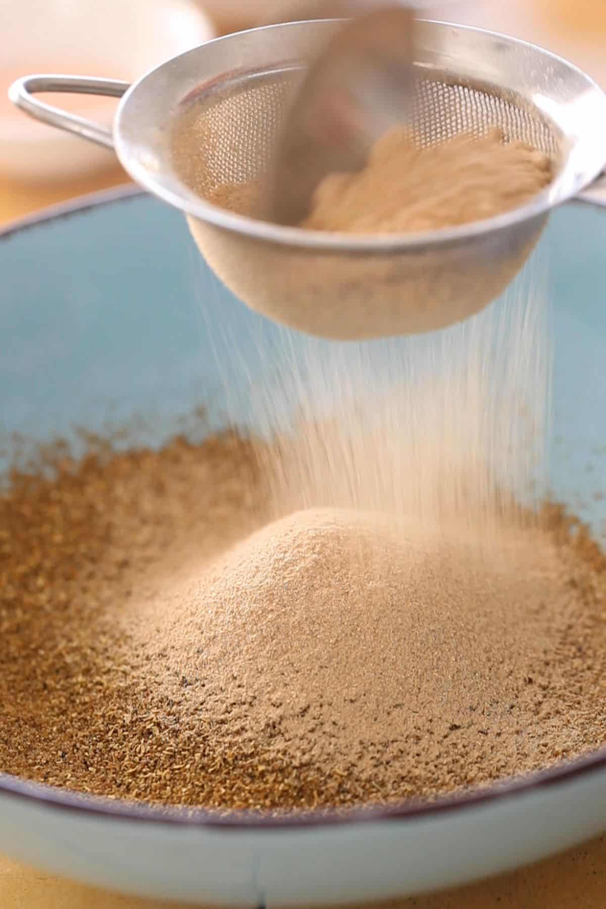 Sieve the dry mango powder over ground spices.