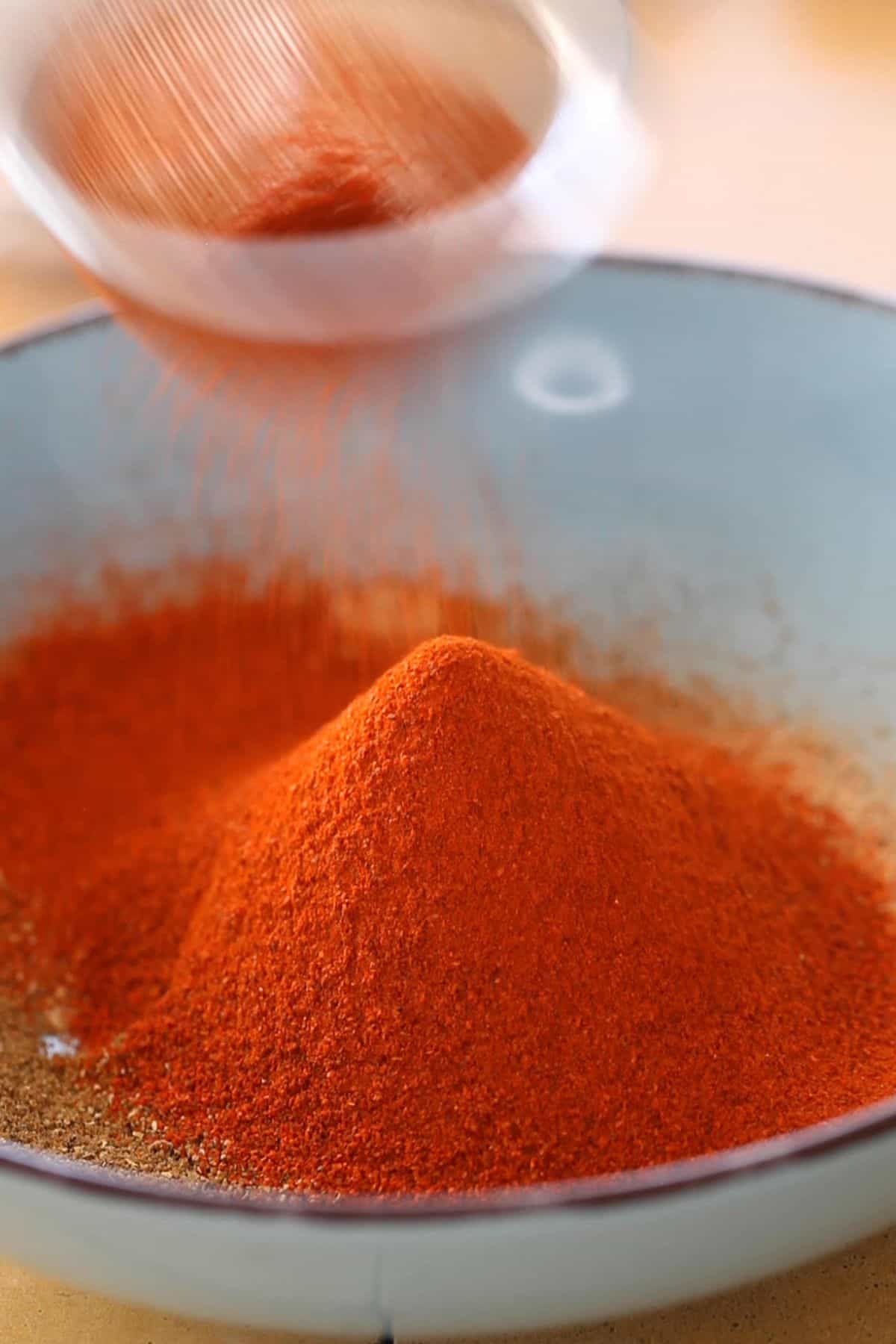 Sieve the red chilli powder over ground spices.