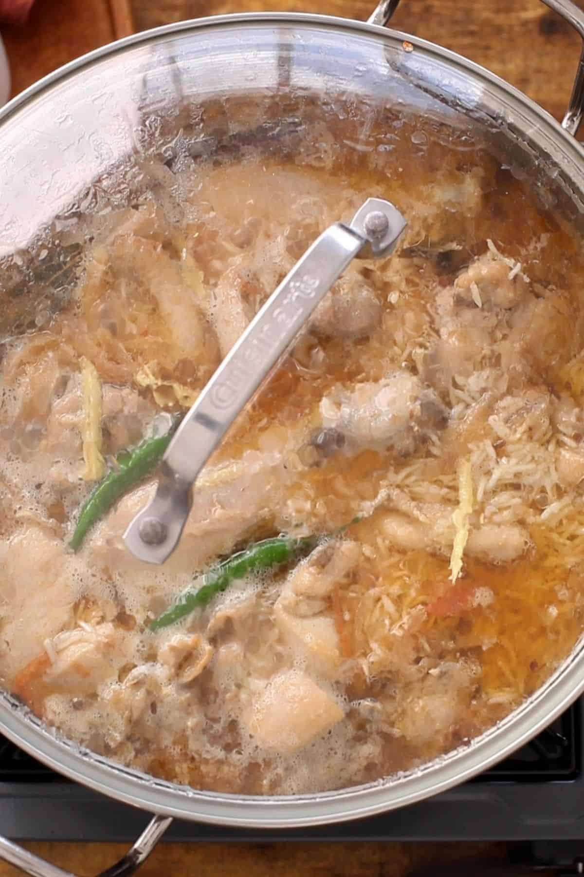 Cooking pot is closed with lid to let the pulao cook.