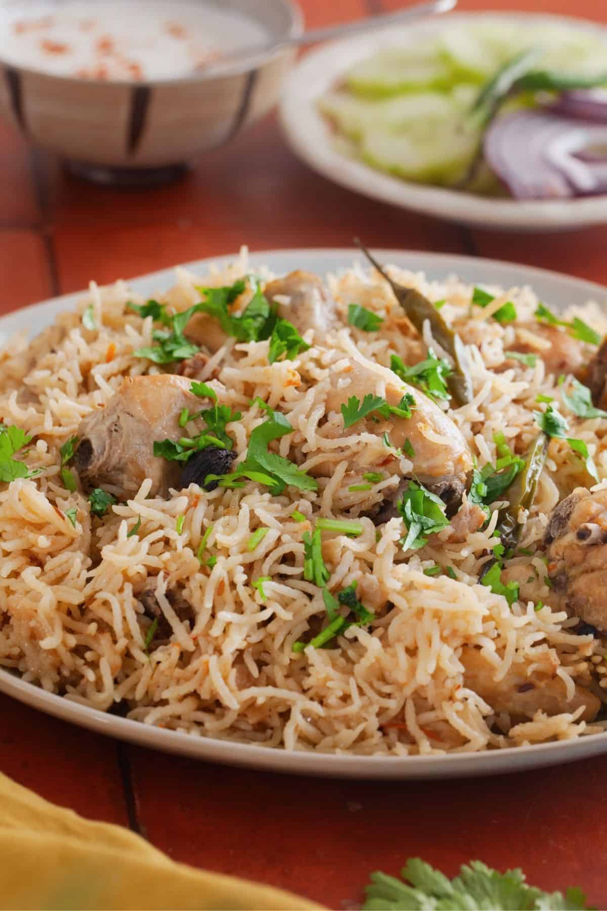 Chicken and rice pilaf garnished with fresh coriander leaves.
