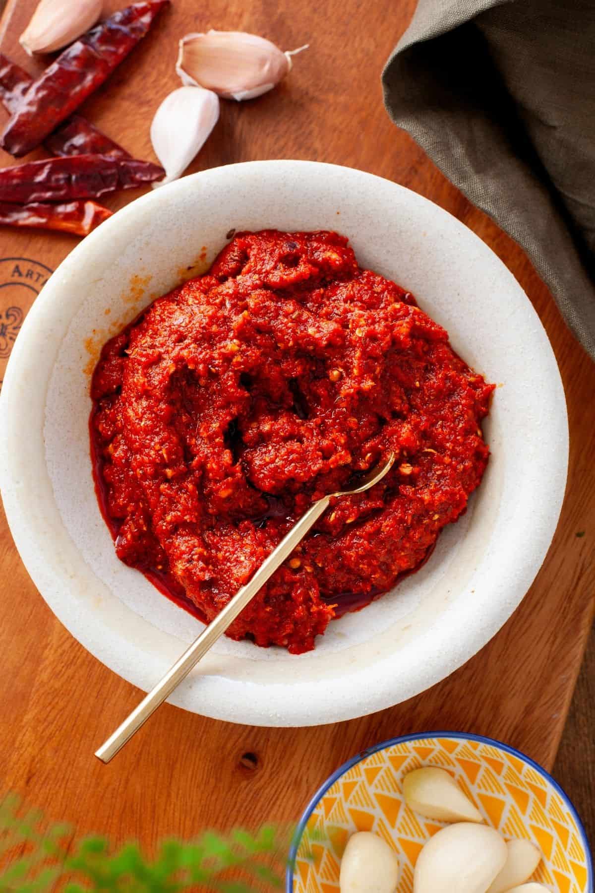 Overhead view of garlic chutney in a stone bowl. 
