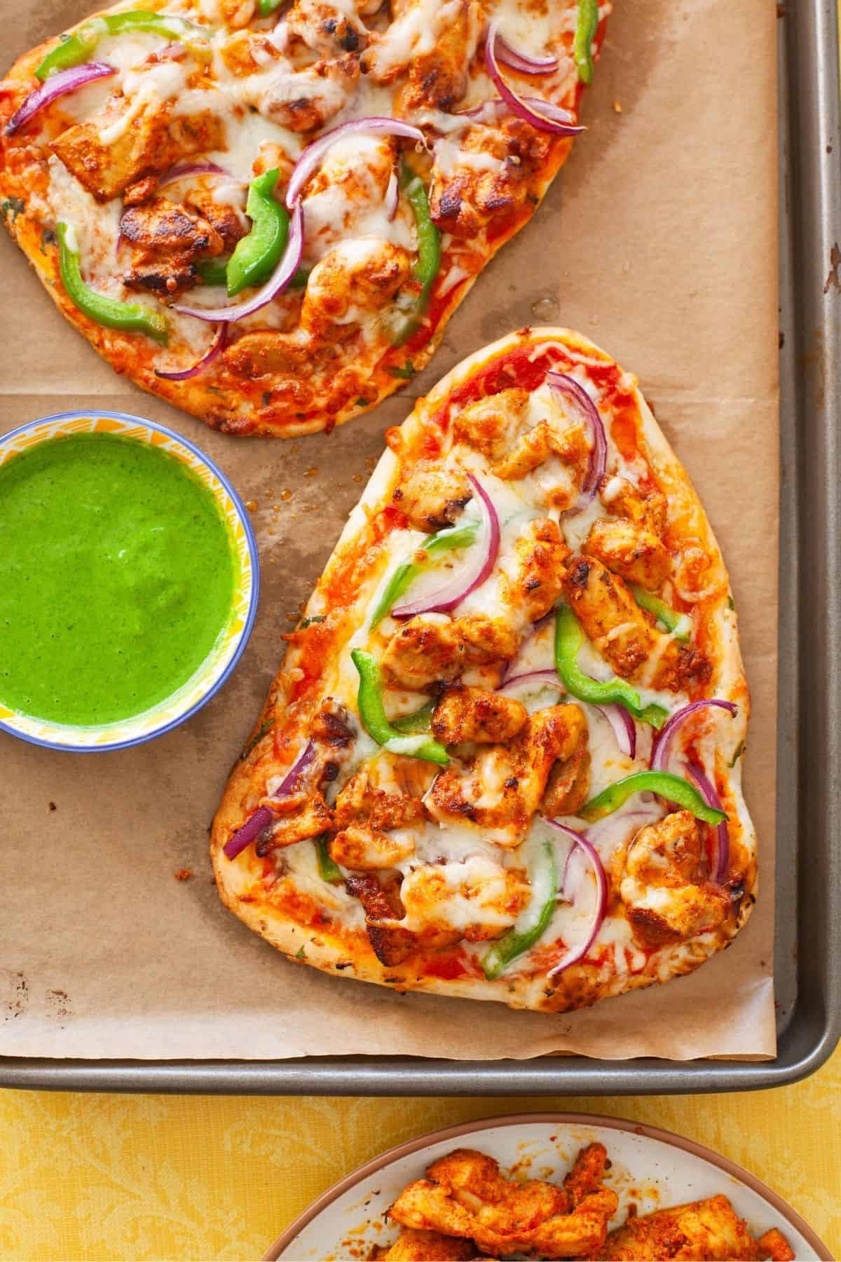 Baked naan chicken tikka pizza.